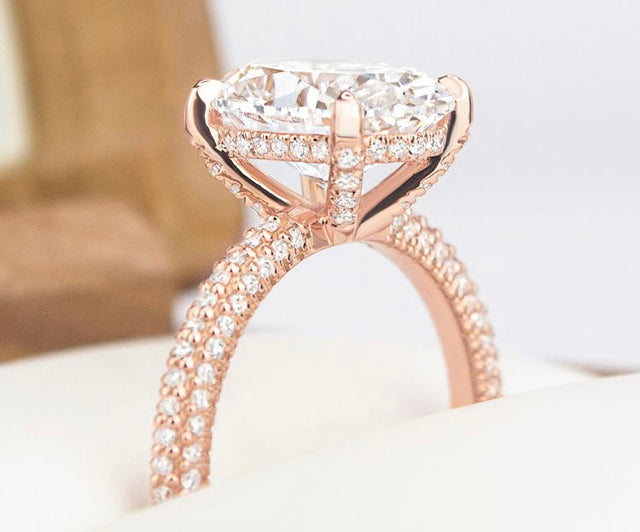 Rose gold pave engagement ring with a cushion-cut diamond