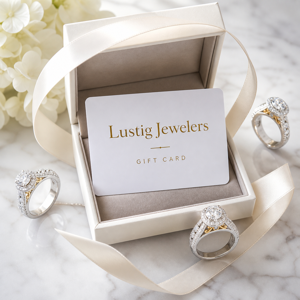 Lustig Jewelers gift card in a jewelry box surrounded by diamond rings