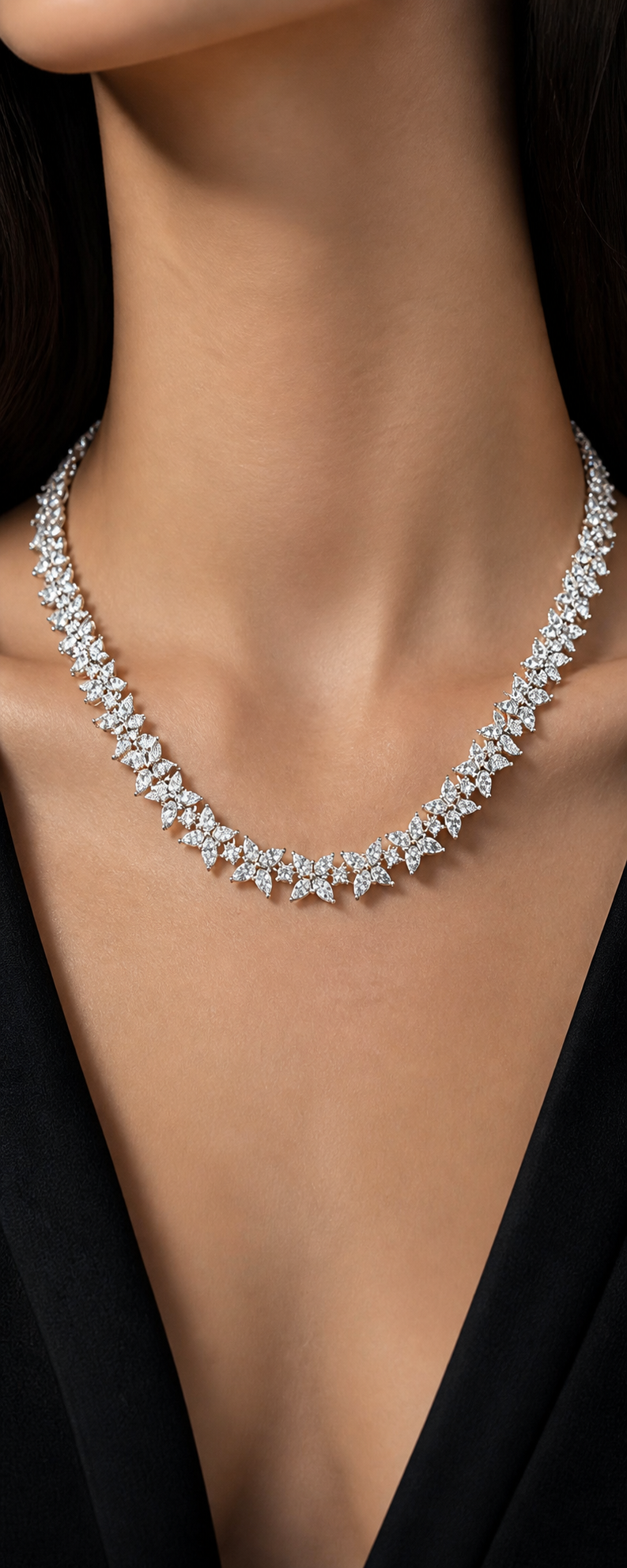 Diamond cluster necklace worn with a black v-neck top