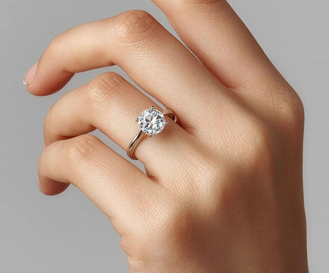 Solitaire engagement ring worn on a hand